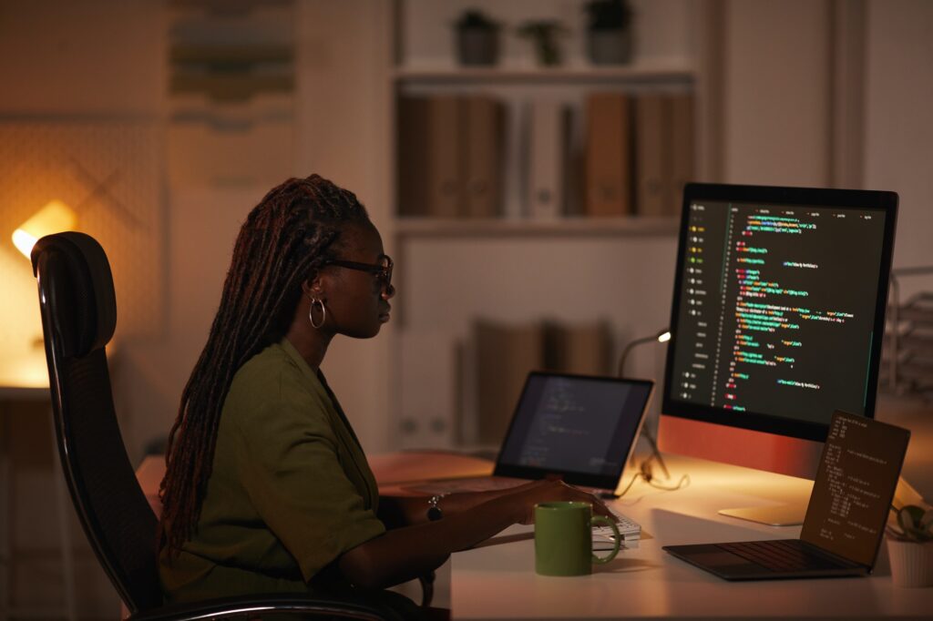 African-American Woman Writing Computer Code