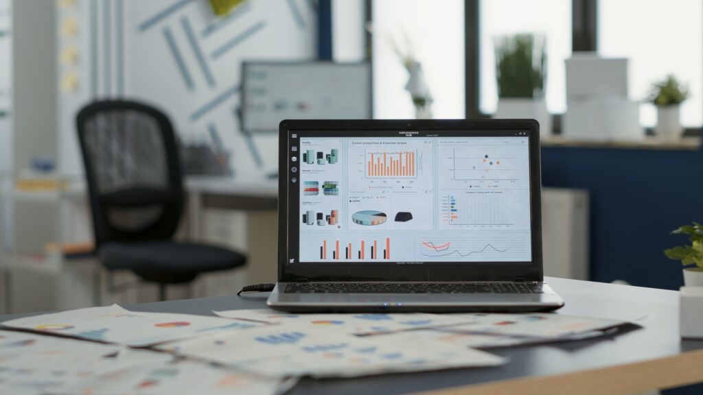 Closeup of laptop screen with enterprise resource planning showing moving charts and growing